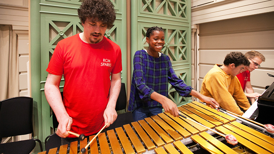 RCM students and Sparks participants playing marimba and piano